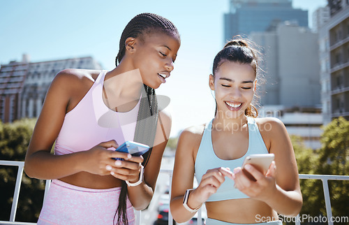 Image of Friends, phone and laughing during exercise for social media, blog or meme while in city together. Women, smartphone and smile with diversity during training, workout or run in Los Angeles in summer