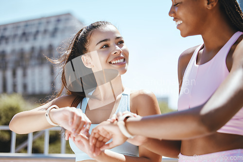 Image of Watch, fitness motivation and friends running for cardio fitness in the city of Orlando together. African runner and women happy about sports training time on digital clock after workout in summer