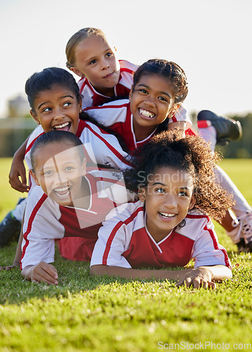 Image of Team, children and happy on field in sports after win in match, game or competition. Girl, smile and together after teamwork in soccer, football or sport on grass for motivation, diversity and unity