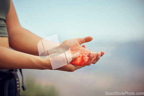 Image of Hand injury, pain or accident of woman hiking outdoor on mountain for fitness and exercise. Closeup of injured or swollen muscle of girl athlete trekking in nature in need of emergency medical help.