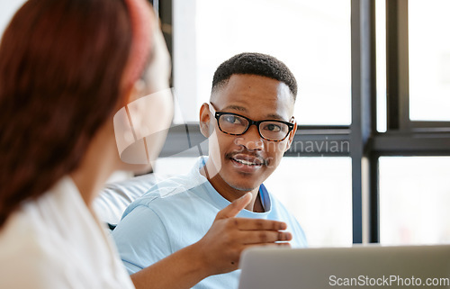 Image of Black man, designer and creative discussion with staff for ideas, strategy and planning in marketing agency startup. Young african guy talking, speaking and explain colleague, employees and teamwork