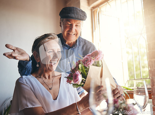 Image of Surprise flowers, love celebration and senior couple with smile to celebrate birthday, anniversary or romantic event in restaurant. Man and woman giving bouquet of roses as present or gift on a date