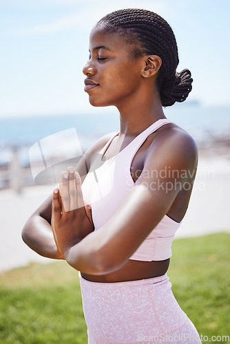 Image of Nature yoga, meditation and black woman praying for spiritual wellness on the grass in the city of San Francisco. Calm, happy and young African girl doing zen exercise for mind health in a park
