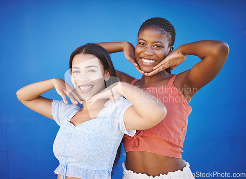 Image of Cute friends happy in studio, women model fashion together on blue background and enjoy summer with portrait. Friendship diversity with funny smile pose, cool black woman and latino girl in Miami