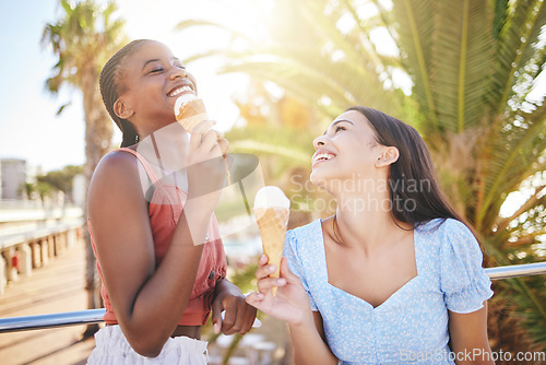 Image of Ice cream, summer and women friends eating on Miami beach for holiday travel, vacation and outdoor youth lifestyle with sunshine lens flare. Happy, diversity teenager couple with icecream dessert