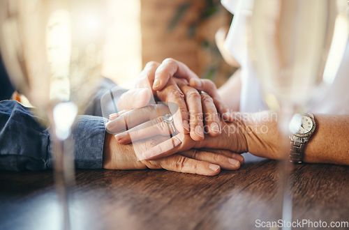 Image of Old couple holding hands, love and support on restaurant date, retirement and care together. Closeup senior man, elderly woman and life partner with hope, trust and kindness for marriage anniversary