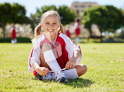 Image of Soccer player, fitness and girl on field, soccer training and sports activity outdoor. Sport, health and exercise with child relax on grass, prepare for football game, checking shoes, happy and smile