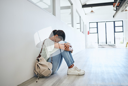 Image of Sad, depression and mental health issue of a woman university student on a floor. Fear, anxiety and study stress of a female from India feeling depressed and overwhelmed from a study fail at home