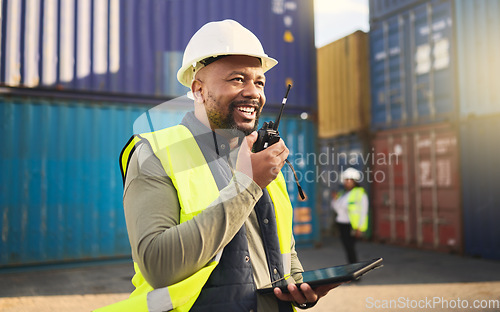 Image of Logistics, radio and a black man in shipping container yard with tablet. Industrial cargo area, happy transport worker talking on walkie talkie in safety gear and working for global freight industry.