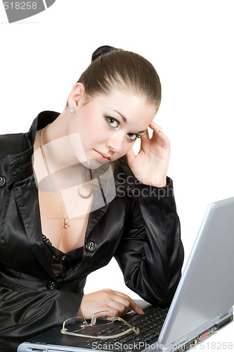 Image of Young businesswoman works on the laptop over white