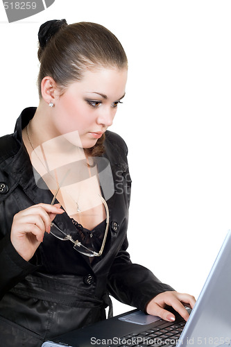 Image of Young businesswoman works on the laptop. Isolated on a white