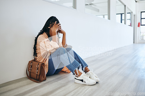 Image of Stress, anxiety and woman on the floor in office with depression, frustration and mental health problems. Burnout, overworked and tired girl sitting and crying with a headache in a modern workplace.
