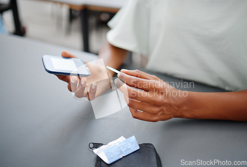 Image of Diabetes, hands and black woman with glucometer on desk checking blood sugar levels. Healthcare, health and student learning how to use glucose meter to test insulin levels for wellness or education