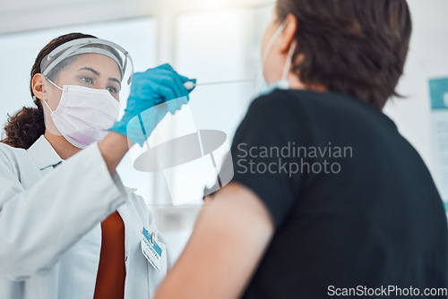 Image of Covid doctor, swab and coronavirus test on patient in hospital for healthcare and medical insurance while wearing face mask for safety and protection. Female gp taking from woman for virus in clinic