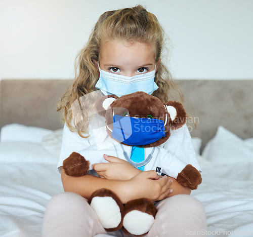 Image of Covid, girl and teddy bear love and care for safety and awareness in pandemic quarantine at home. Portrait of a little kid playing doctor holding cute fluffy toy with mask for healthcare in pandemic