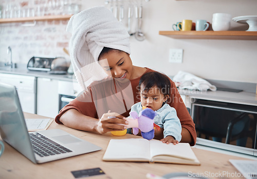 Image of Mother, baby and down syndrome with laptop for work on web, study or education in house. Multitasking, mom and child with computer, book and toys for learning, play and working while home in kitchen