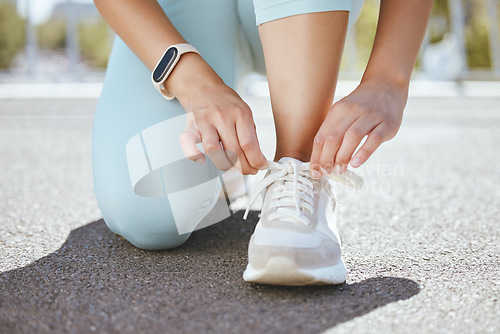 Image of Tying shoes, running training and woman start workout, exercise and sports fitness in urban city outdoors. Closeup athlete feet, runner prepare sneakers and ready for cardio challenge performance