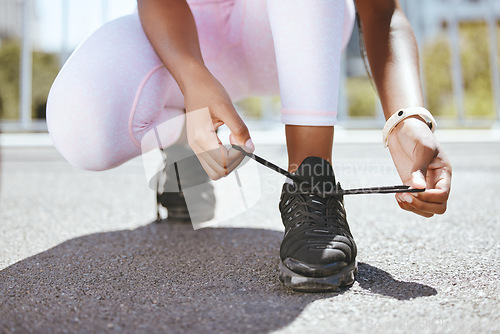 Image of Tie shoes, marathon running and woman start training workout, exercise and sports fitness in outdoor urban city. Closeup athlete feet, runner foot sneakers and ready for cardio challenge performance