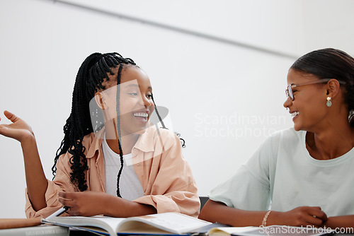 Image of Student, education and university with girl friends learning in class while laughing or joking at their desk. Scholarship, university and study with a black woman pupil and friend in college to learn