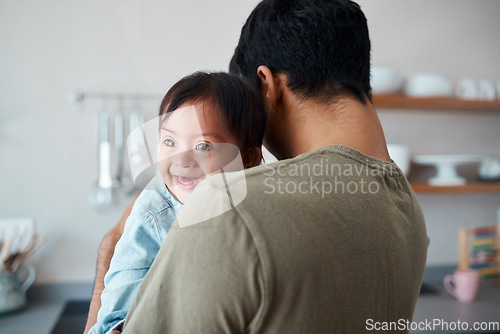 Image of Down syndrome, baby and father bonding in a kitchen, happy and relax in their home together. Disability, development and child care for special needs with loving parent holding and comfort newborn