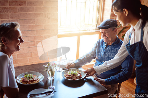 Image of Happy senior couple at restaurant, waitress service with smile, and ready to eat healthy food with glass of champagne to celebrate anniversary. Woman in hospitality, serve lunch and drinks to people