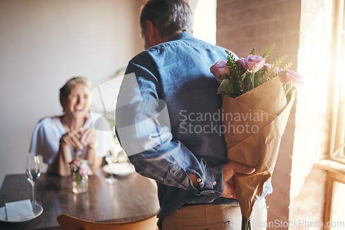 Image of Surprise, flowers and senior couple in celebration of an anniversary, marriage or birthday at a restaurant. Elderly man giving bouquet of roses to woman during dinner date for love at a coffee shop