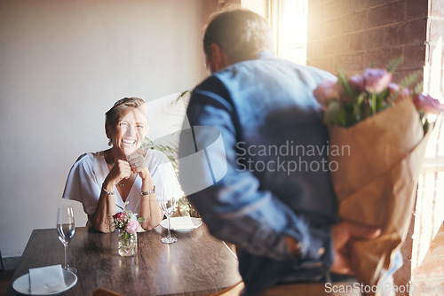 Image of Elderly, couple and flowers on a date for surprise, love and romance in their house. Senior woman, man and retirement together with bouquet to celebrate marriage, birthday or anniversary in the home