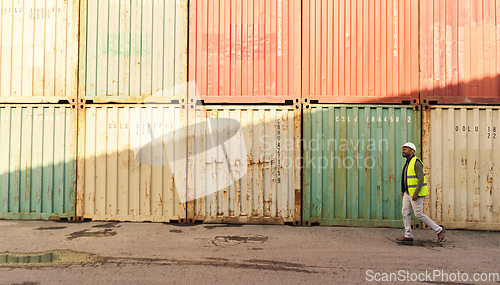 Image of Shipping, logistics worker in shipyard port and walking by freight cargo containers. Transport of commercial goods, international delivery and inventory management creates a distribution supply chain