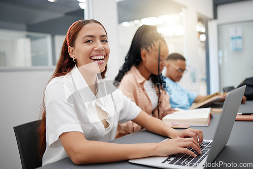 Image of University, internet and student typing notes on laptop with smile at a table in a classroom of school. Portrait of a girl in college learning education in lecture and happy about campus wifi for pc