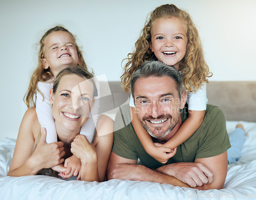 Image of Family smile, happy portrait and children giving love hug to parents, happy on holiday vacation and relax on bed in home. Mother and father with happiness in bedroom with kids in the morning