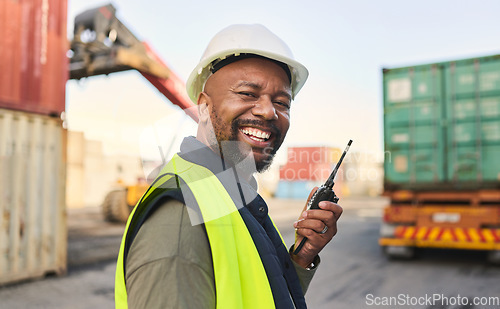 Image of Logistics, communication and black man talking on walkie talkie while working at a storage port with container. Portrait of an African manufacturing manager speaking on tech while shipping cargo