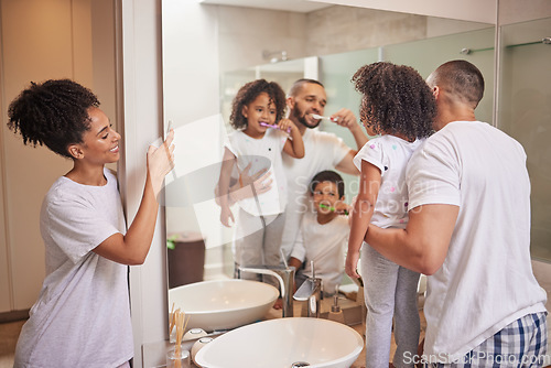 Image of Father teaching kids to brush teeth in bathroom, happy mom photograph children learn dental health and morning in miami home. Parents clean mouth, personal hygiene and photo of family check mirror