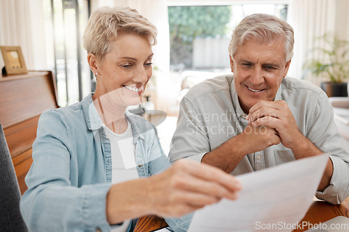 Image of Happy couple, reading and paperwork or document for bill, mortgage or retirement plan or payout while sitting at home. Mature man and woman busy with tax compliance or finance form for pensioners