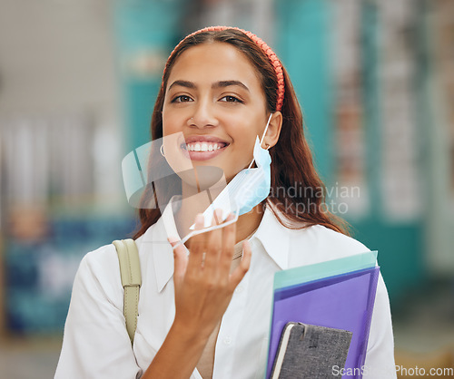 Image of College student take off face mask for end of covid at university for learning, studying and back to school education in Colombia. Portrait happy woman smile for corona virus freedom at campus