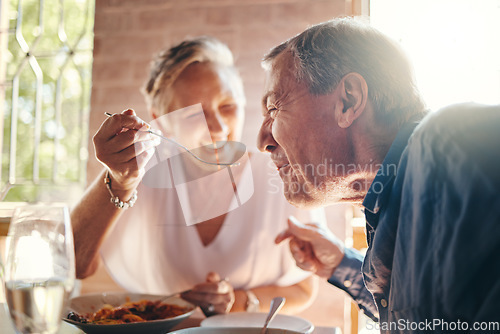 Image of Couple, love and food with a senior man and woman on a date in a restaurant while eating on holiday. Travel, romance and dating with an elderly male and female pensioner enjoying a meal together