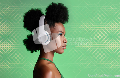 Image of Black woman, music headphones and fashion hairstyle on studio background with green geometric patterns and makeup cosmetics. Style, trend or pride for beauty model listening to Jamaican radio podcast