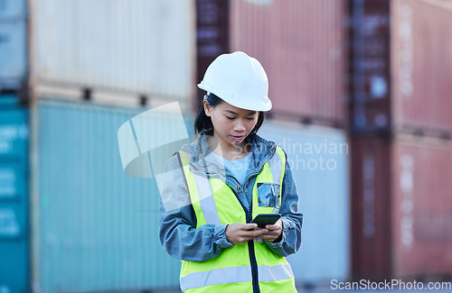 Image of Warehouse, shipping and manager on a phone at factory plant, text and check delivery checklist and stock on online app. Cargo, logistics and supply chain management by asian woman control inventory