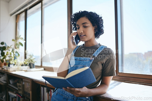 Image of Woman with notebook, artist talking on smartphone call and planning creative exhibition. Audio conversation on mobile, small business communication for Indian entrepreneur and reading in studio