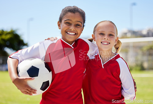 Image of Portrait of girls on field, sports and soccer player, smiling with teammate. Soccer ball, football and young kids having fun on summer day before match or game. Team, friends and teamwork in sport