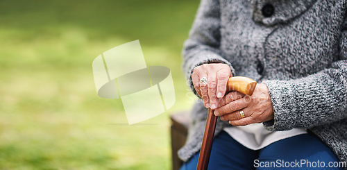 Image of Old woman, hands and cane on park bench or nature in retirement. Senior retired disabled female pensioner, wood walking stick and wooden mobility aid support for balance and old age problem.