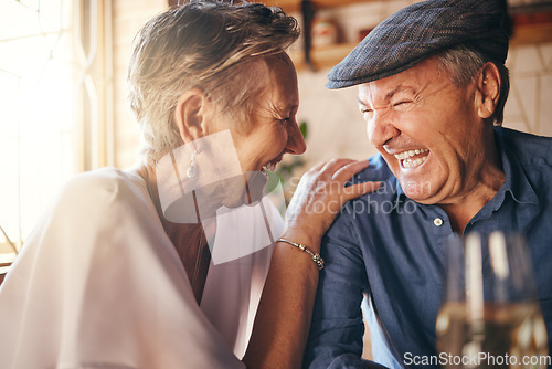 Image of Senior, couple and laugh after comic joke together in restaurant for bonding time. Smile, man and woman in retirement laughing at funny conversation with love, happiness and comedy in cafe with wine