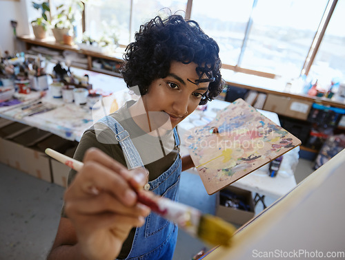 Image of Painting studio, creative and art woman using brush to oil paint an artwork design, sketch or designer drawing. Inspiration, workshop and canvas paper for artist painter working on watercolor graphic