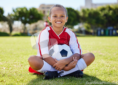 Image of Sports, happy and girl. relax on soccer field after game, competition or fitness cardio exercise. Sitting, kid child or young athlete with smile after youth football, practice or training workout