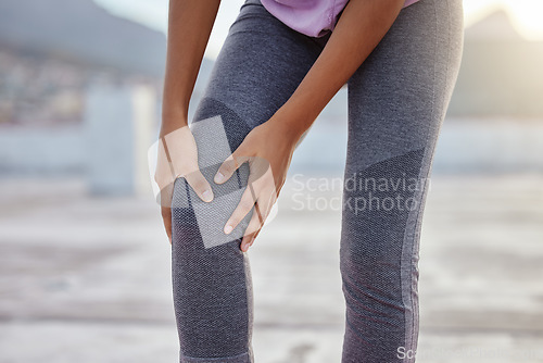 Image of Knee injury, fitness and woman with pain while training for health in the city of Turkey. Legs and hands of an athlete runner with medical emergency after running, cardio or workout accident