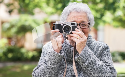 Image of Retirement, relax and elderly woman with photographer hobby to enjoy pension leisure in garden. Satisfied, focused and senior lady with camera busy with nature photography outside nursing home.