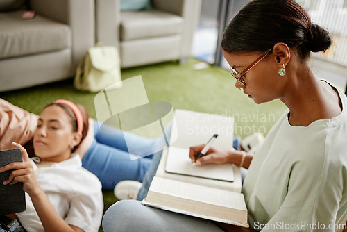 Image of Writing, studying and woman student exam learning with a friend busy with university education. College students together with diversity, tired study burnout and scholarship work in a school dorm