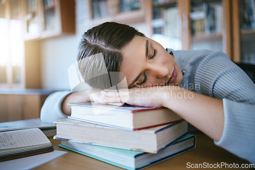 Image of Sleeping, tired and fatigue student with books studying for university exam, learning and knowledge in a library or education workspace. English, literature college woman burnout with school research