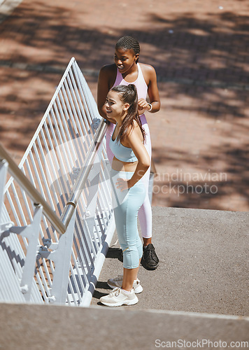 Image of Exercise, running and friends relax and take a break from morning workout in a city, talking and bonding on steps. Health, fitness and training by athletic females enjoying rest and conversation