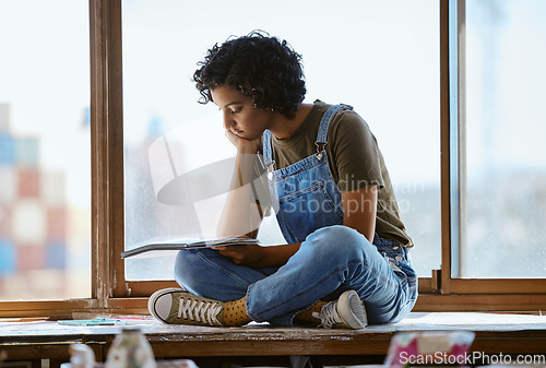 Image of Woman, thinking and drawing by window in art studio, Indian creative gallery and designer workshop. Artist, painter or person with notebook or sketchbook planning painting exhibition expo for auction