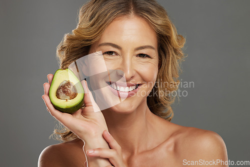 Image of Skincare, avocado and smile on face of woman with fruit in hand for health, wellness and care. Model, skin and happy with avo in hand for healthy body, hair and beauty with facial product from nature